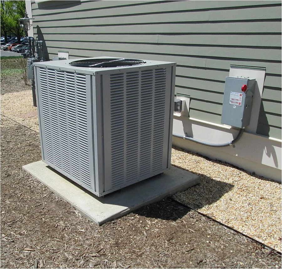 Outdoor condensing unit installed on a concrete base